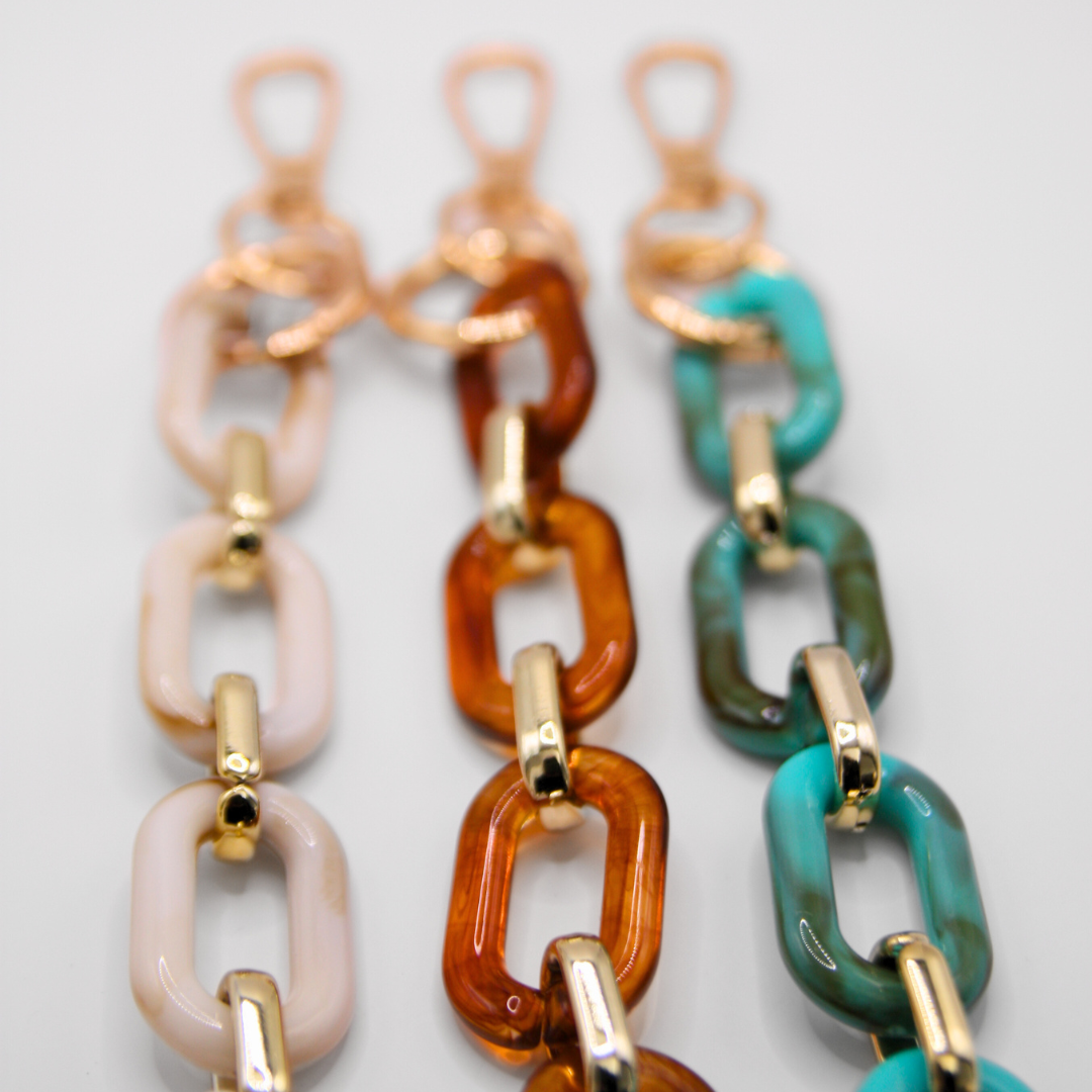 Example of 3 different coloured crossbody phone strap. Focused with details.
